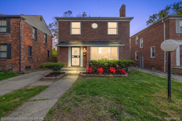 16573 Griggs St, Detroit, MI 48221 - view of front of home featuring a chimney, a front lawn, and brick siding