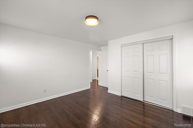 16573 Griggs St, Detroit, MI 48221 - unfurnished bedroom with dark wood finished floors and a closet