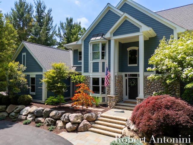 1977 Emerald Glen Ct NE, Ada, MI 49301 - view of front of property featuring roof with shingles and stone siding