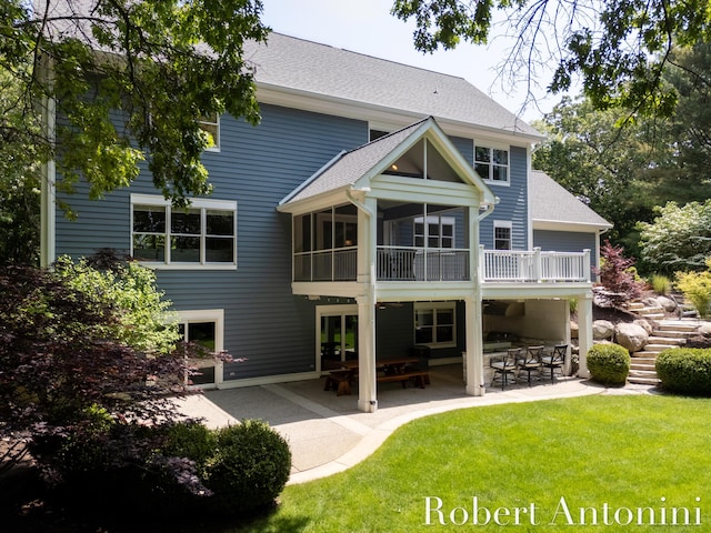 1977 Emerald Glen Ct NE, Ada, MI 49301 - back of property with a patio area, roof with shingles, and a yard