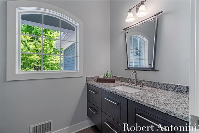1977 Emerald Glen Ct NE, Ada, MI 49301 - bathroom with plenty of natural light, vanity, and tile patterned floors