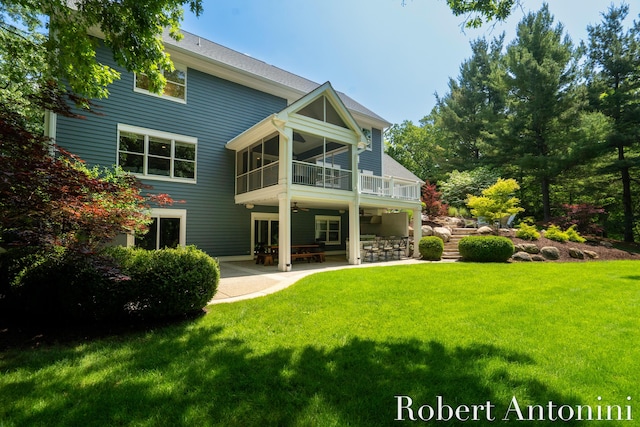 1977 Emerald Glen Ct NE, Ada, MI 49301 - rear view of house with ceiling fan, a patio, and a yard