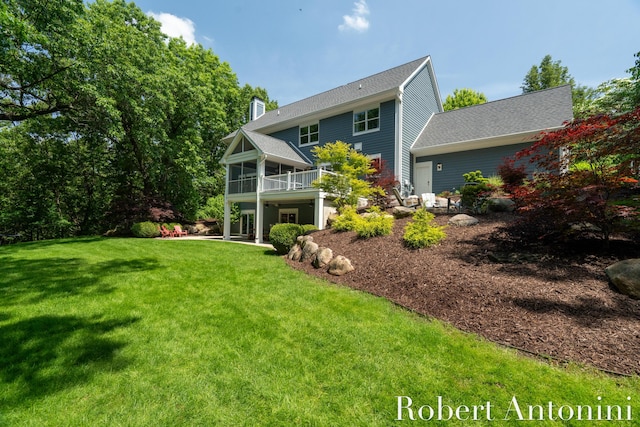 1977 Emerald Glen Ct NE, Ada, MI 49301 - back of house with a lawn, a chimney, a balcony, and a sunroom