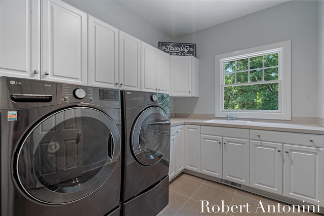 1977 Emerald Glen Ct NE, Ada, MI 49301 - laundry room featuring washer and dryer, cabinet space, and light tile patterned flooring