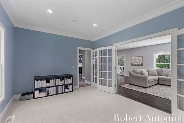 1977 Emerald Glen Ct NE, Ada, MI 49301 - living area with french doors, ornamental molding, recessed lighting, carpet floors, and wood finished floors