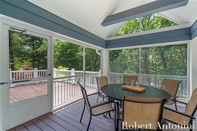 1977 Emerald Glen Ct NE, Ada, MI 49301 - sunroom / solarium featuring lofted ceiling, outdoor dining area, healthy amount of natural light, and view of scattered trees