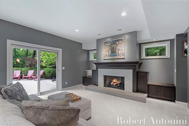 1977 Emerald Glen Ct NE, Ada, MI 49301 - carpeted living room with recessed lighting, a lit fireplace, and plenty of natural light