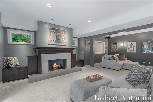 1977 Emerald Glen Ct NE, Ada, MI 49301 - carpeted living area with recessed lighting and a lit fireplace