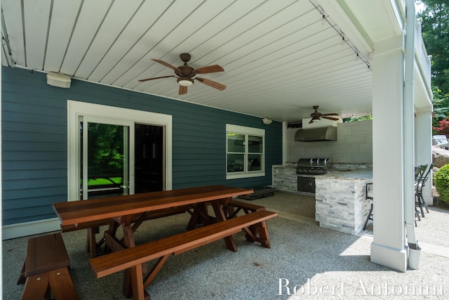 1977 Emerald Glen Ct NE, Ada, MI 49301 - view of patio with an outdoor kitchen, ceiling fan, and outdoor dining area