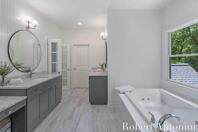 1977 Emerald Glen Ct NE, Ada, MI 49301 - full bath with two vanities and a whirlpool tub