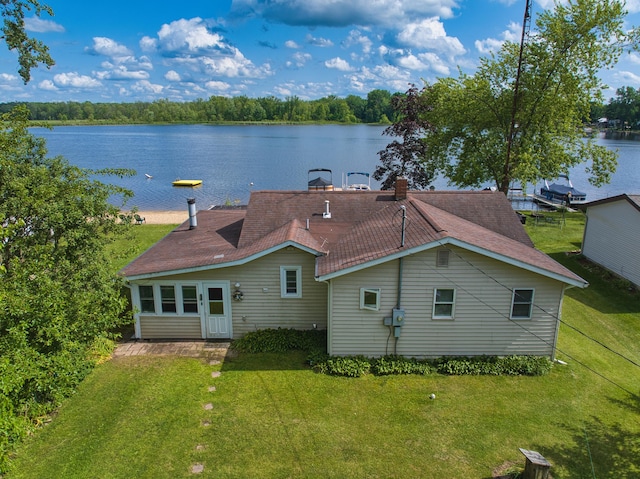 135 Teal Dr, Coldwater, MI 49036 - rear view of property with a water view, a yard, a shingled roof, and a chimney