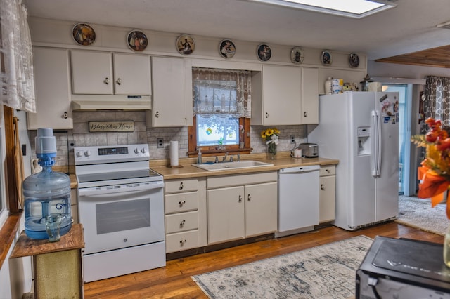135 Teal Dr, Coldwater, MI 49036 - kitchen with white appliances, under cabinet range hood, light countertops, backsplash, and white cabinets