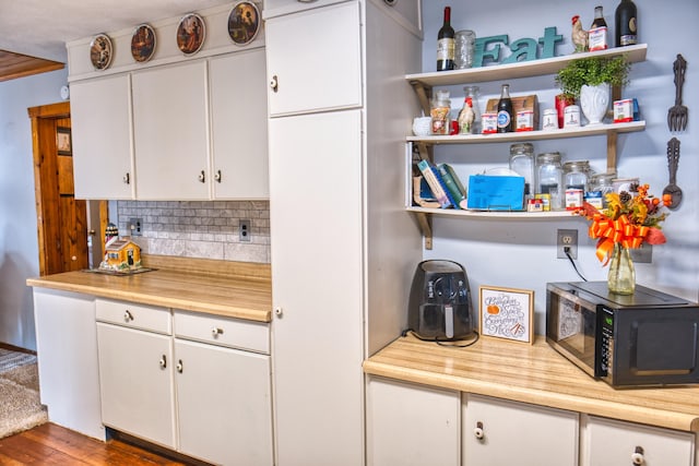 135 Teal Dr, Coldwater, MI 49036 - kitchen with decorative backsplash, white cabinetry, dark wood-type flooring, open shelves, and wood counters