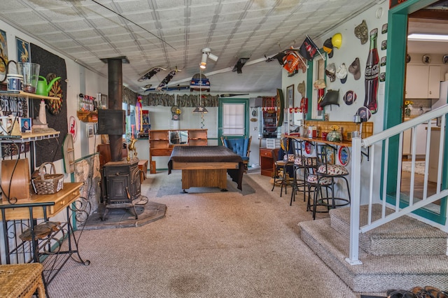 135 Teal Dr, Coldwater, MI 49036 - recreation room featuring a wood stove and carpet flooring