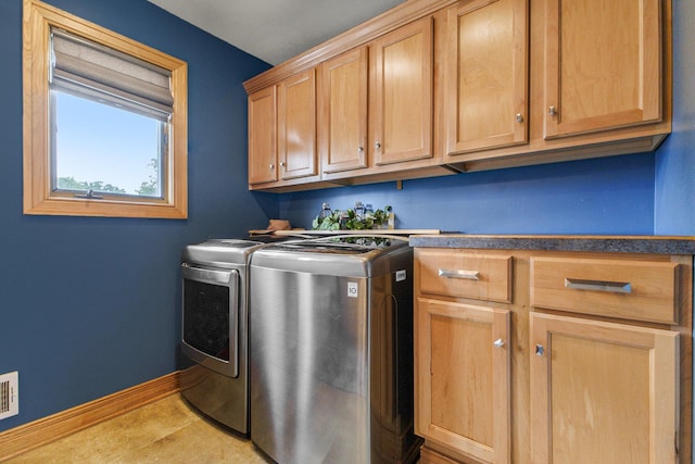 9749 48th Ave, Allendale, MI 49401 - laundry room with independent washer and dryer, cabinet space, and light tile patterned flooring