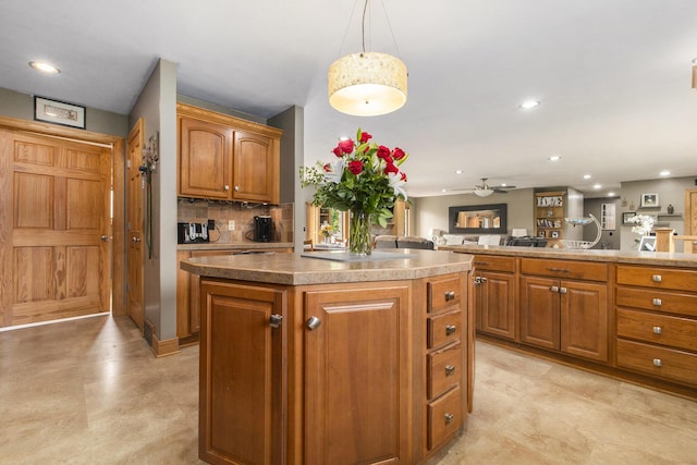 9749 48th Ave, Allendale, MI 49401 - kitchen with a center island, brown cabinets, a ceiling fan, recessed lighting, and decorative light fixtures