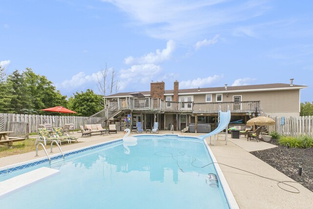 9749 48th Ave, Allendale, MI 49401 - view of pool with a water slide, stairway, a fenced backyard, a deck, and a patio