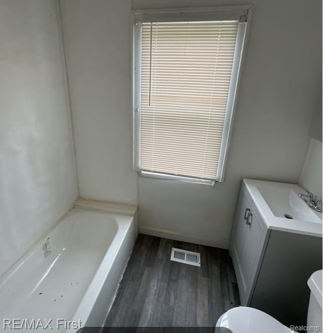1732 Burlingame St, Detroit, MI 48206 - full bath with wood finished floors, a tub to relax in, and vanity