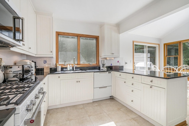 6368 E Lake Ln, Sawyer, MI 49125 - kitchen featuring white appliances, a peninsula, tasteful backsplash, lofted ceiling, and white cabinets