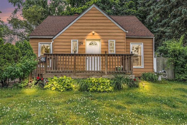134 Honeoye St SW, Grand Rapids, MI 49548 - bungalow-style home featuring a shingled roof, a front yard, and a wooden deck