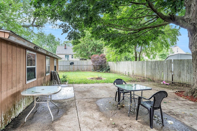 134 Honeoye St SW, Grand Rapids, MI 49548 - fenced backyard with an outdoor fire pit and a patio area