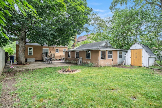 134 Honeoye St SW, Grand Rapids, MI 49548 - back of property with a patio area, a shed, and an outdoor fire pit