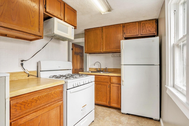 436 Quimby St NE, Grand Rapids, MI 49505 - kitchen featuring white appliances, light countertops, brown cabinetry, and decorative backsplash