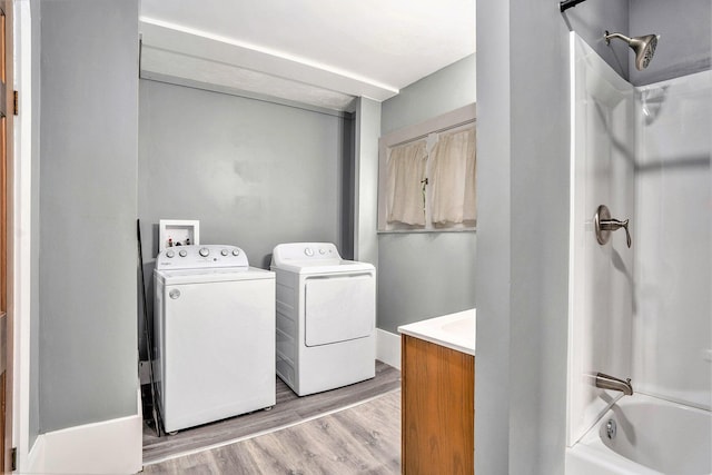 436 Quimby St NE, Grand Rapids, MI 49505 - laundry room featuring washing machine and clothes dryer and light wood finished floors
