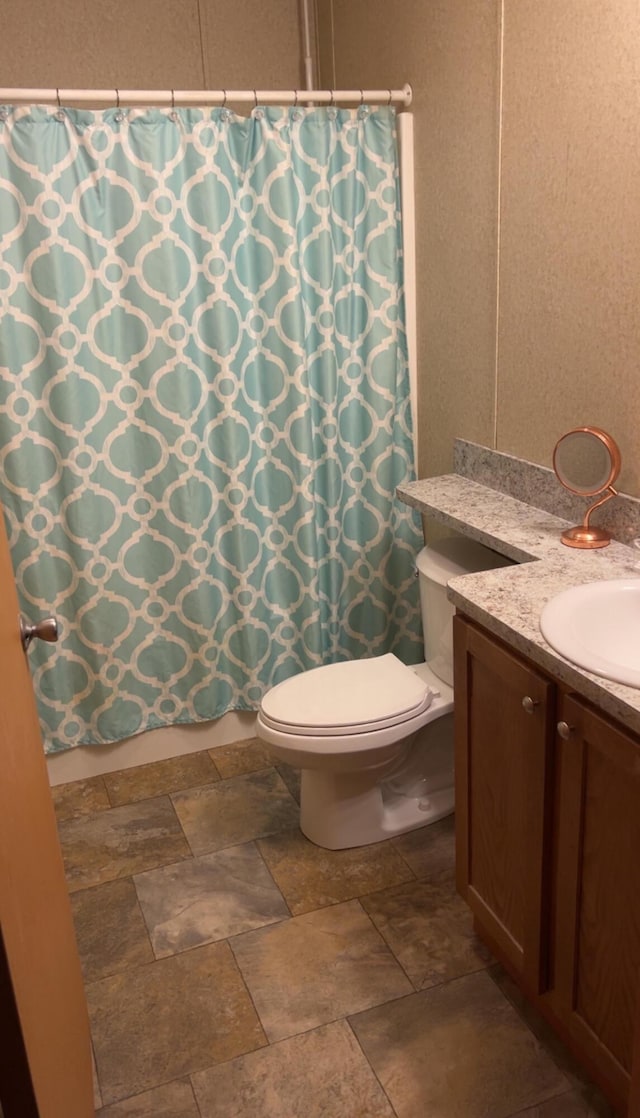 3728 Richardson St, Muskegon, MI 49442 - bathroom with vanity, stone finish flooring, and a shower with shower curtain
