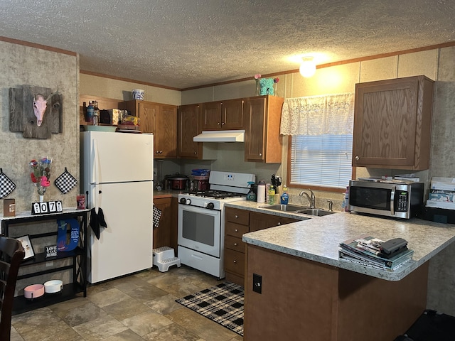 3728 Richardson St, Muskegon, MI 49442 - kitchen with white appliances, under cabinet range hood, a peninsula, light countertops, and a textured ceiling