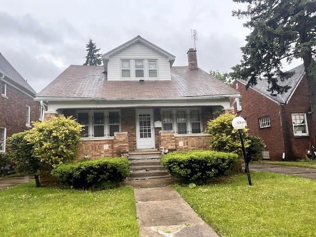 13310 Wilshire Dr, Detroit, MI 48213 - bungalow-style home with a chimney, covered porch, and a front lawn