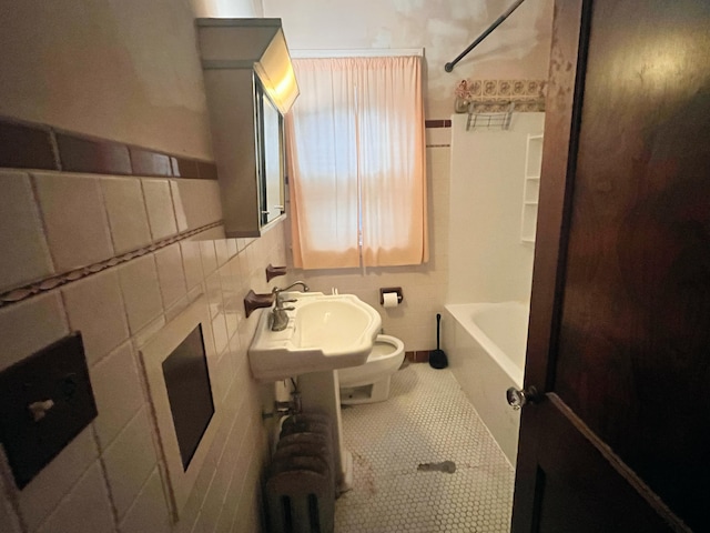 13310 Wilshire Dr, Detroit, MI 48213 - bathroom with radiator heating unit, bathing tub / shower combination, tile walls, and tile patterned flooring