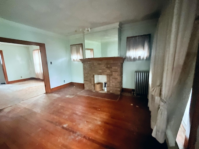 13310 Wilshire Dr, Detroit, MI 48213 - unfurnished living room featuring radiator, a brick fireplace, and wood finished floors