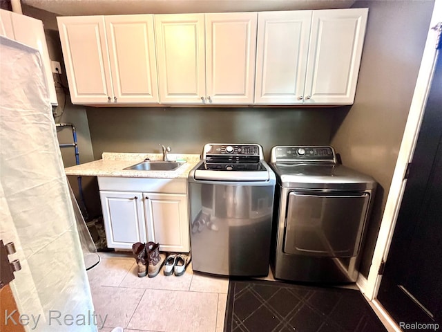 7949 Church Rd, Grosse Ile, MI 48138 - laundry room with cabinet space, washing machine and clothes dryer, and light tile patterned flooring