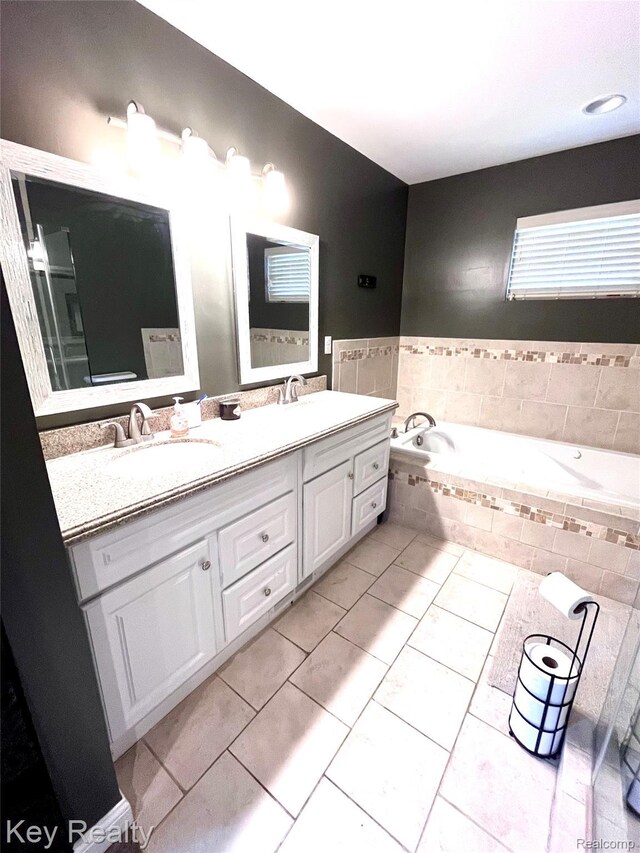 7949 Church Rd, Grosse Ile, MI 48138 - bathroom featuring double vanity, a garden tub, and tile patterned flooring