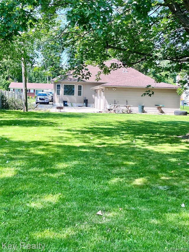 7949 Church Rd, Grosse Ile, MI 48138 - back of property featuring a yard