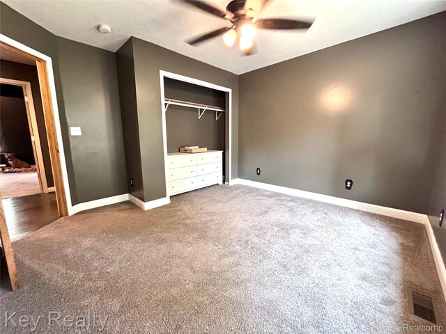 7949 Church Rd, Grosse Ile, MI 48138 - unfurnished bedroom featuring carpet, a closet, and ceiling fan