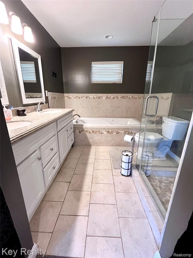 7949 Church Rd, Grosse Ile, MI 48138 - bathroom with double vanity, a garden tub, tile patterned floors, and a shower stall