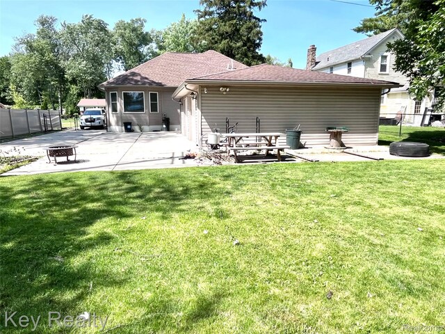 7949 Church Rd, Grosse Ile, MI 48138 - back of house with a patio, a chimney, and roof with shingles