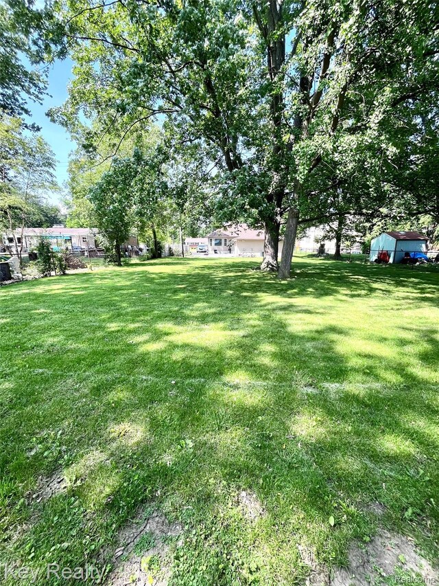 7949 Church Rd, Grosse Ile, MI 48138 - view of grassy yard with an outbuilding