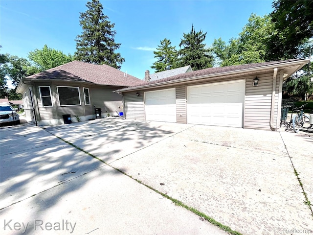 7949 Church Rd, Grosse Ile, MI 48138 - view of front of house with a garage and driveway