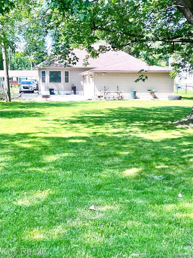 7949 Church Rd, Grosse Ile, MI 48138 - rear view of house with a lawn