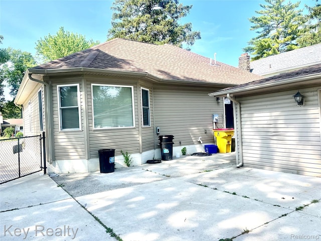 7949 Church Rd, Grosse Ile, MI 48138 - back of property with roof with shingles and a patio area