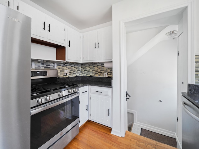 2391 Cambridge Rd, Berkley, MI 48072 - kitchen with appliances with stainless steel finishes, dark countertops, backsplash, and white cabinetry