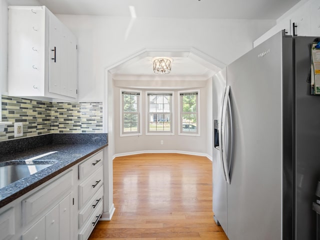 2391 Cambridge Rd, Berkley, MI 48072 - kitchen featuring stainless steel fridge with ice dispenser, dark countertops, light wood-style flooring, and white cabinets