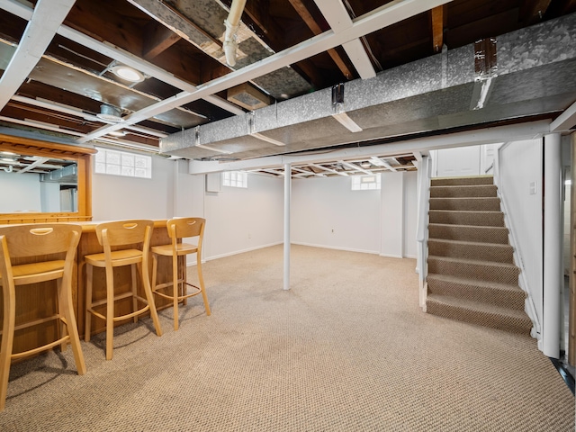 2391 Cambridge Rd, Berkley, MI 48072 - below grade area with stairway, a bar, and light colored carpet