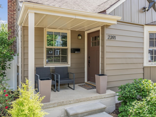 2391 Cambridge Rd, Berkley, MI 48072 - view of exterior entry featuring covered porch, board and batten siding, and roof with shingles