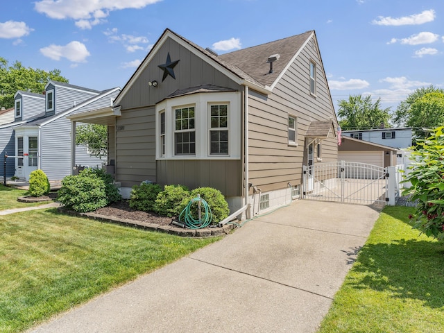 2391 Cambridge Rd, Berkley, MI 48072 - bungalow-style home with a gate, board and batten siding, a front yard, and roof with shingles