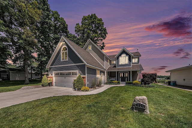 828 Russmiller Loop, Brooklyn, MI 49230 - view of front of home featuring driveway, a front lawn, a metal roof, covered porch, and a garage