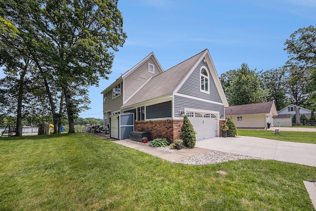 828 Russmiller Loop, Brooklyn, MI 49230 - view of front of property with concrete driveway, brick siding, a garage, and a front yard